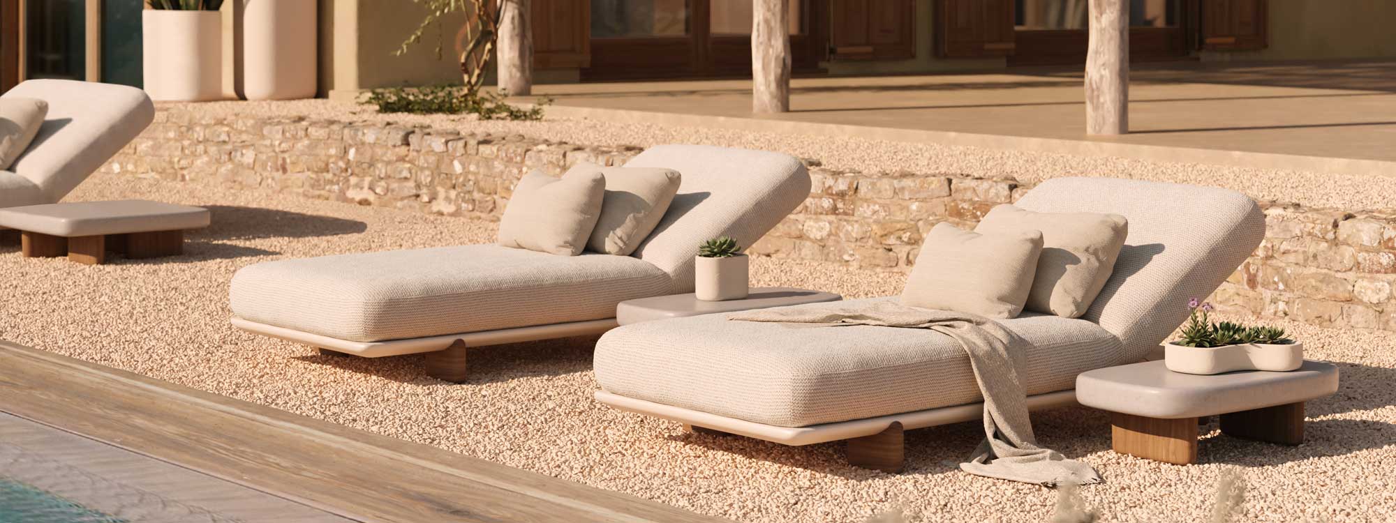 Image of row of Milos sun loungers by Vondom on gravel poolside