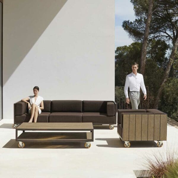 Image of Vondom Vineyard modern garden sofa and lounge chair in weathered teak and aluminium on sunny terrace