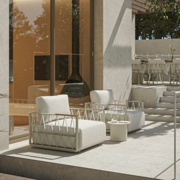 Image of pair of Oiside white Ava garden chairs with plump white cushions on sunny terrace
