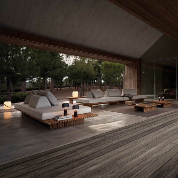 Image of Gloster Deck modern outdoor sofa in a contemporary garden room at dusk