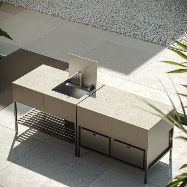 Image of Oiside Eterna minimalist exterior kitchen with fridge units, shown in sunny courtyard