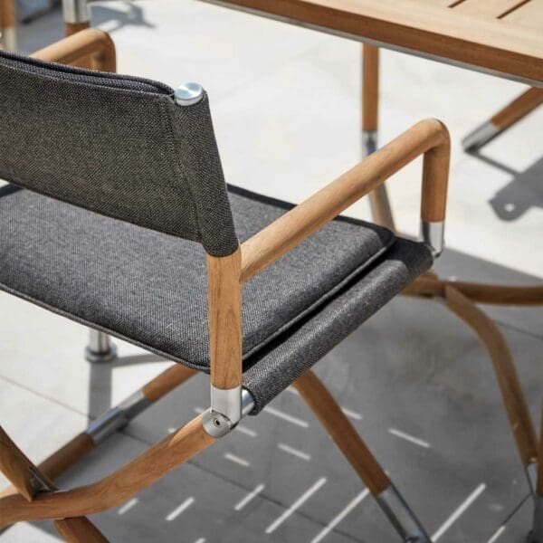 Image of Navigator luxury teak furniture by Gloster, casting shadows on a sunny terrace