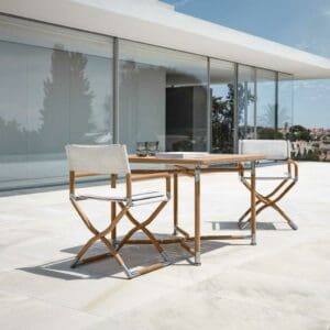 Image of Navigator folding teak table and chairs with white seats & backs by Gloster