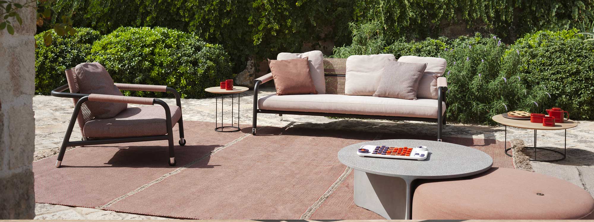 Image of Astra reclining garden sofa and lounge chair, together with Aspic and Zefiro low tables by RODA, on sunny terrace