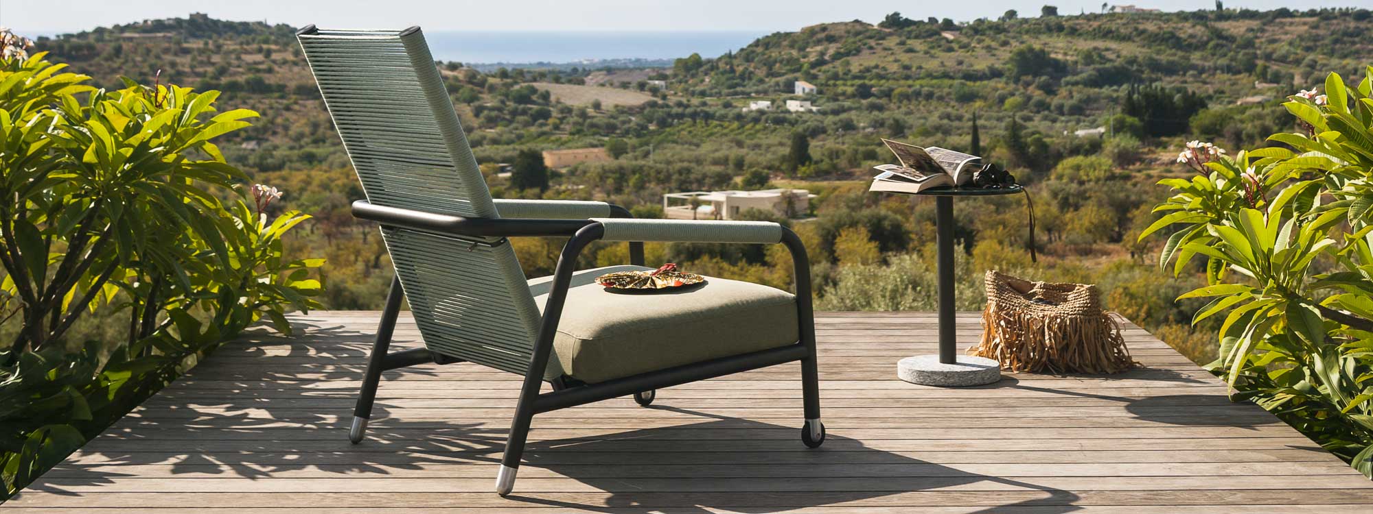 Image showing the acrylic cord back of Astra high backed reclining garden chair by RODA, with rolling Italian countryside in the background