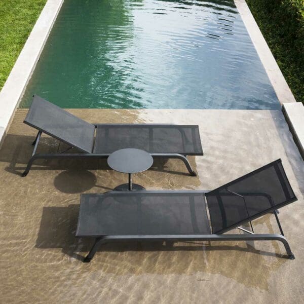 Image of pair of Surfer sun loungers stood in shallow water of swimming pool