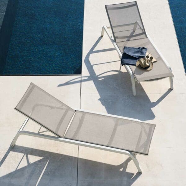 Image of pair of Surfer white sun loungers on sunny poolside