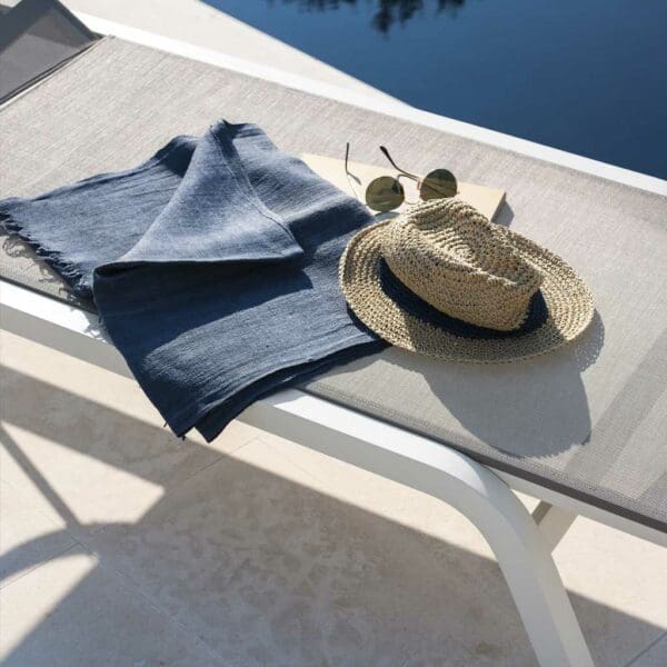 Image of towel and panama hat placed on white Surfer sun lounger by RODA
