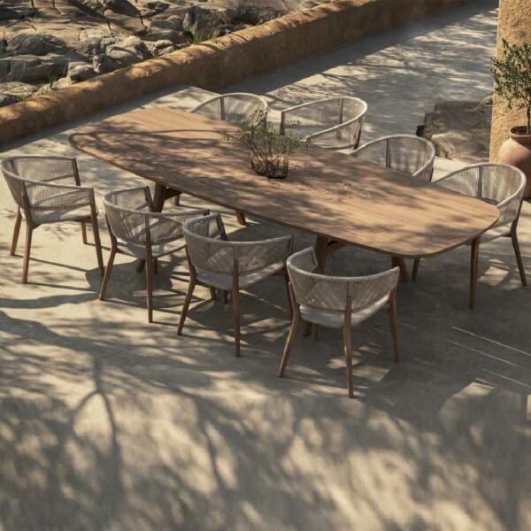 Image of Royal Botania Carés teak chair and Zidiz contemporary garden table in sun and shade of rustic terrace
