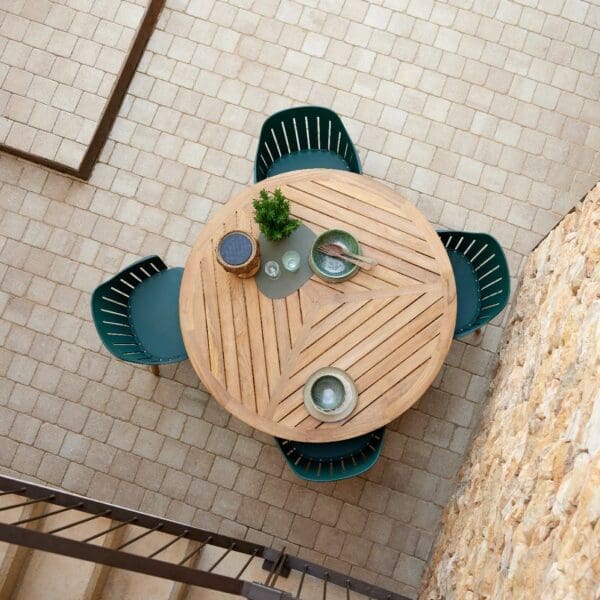 Image of aerial view showing the geometric design of Define teak table, together with Choice dark-green garden chairs