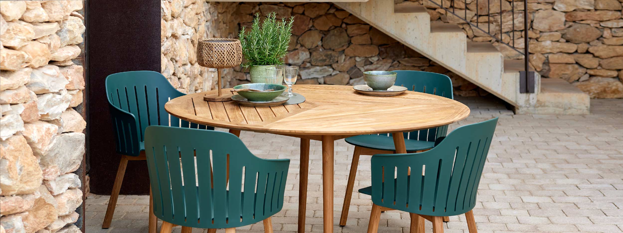 Image of Define contemporary round teak table with geometric design together with Choice recycled plastic garden chairs by Cane-line