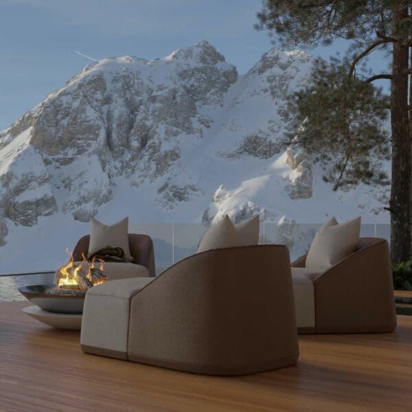 Image of pair of Flow upholstered garden lounge chairs around Flama marble fire pit with snow-covered mountains in the background