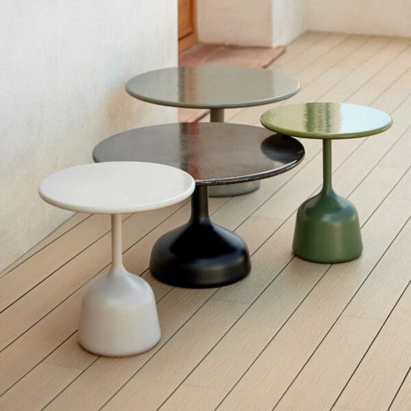 Image of collection of Glaze modern garden low tables by Cane-line in various different colour finishes