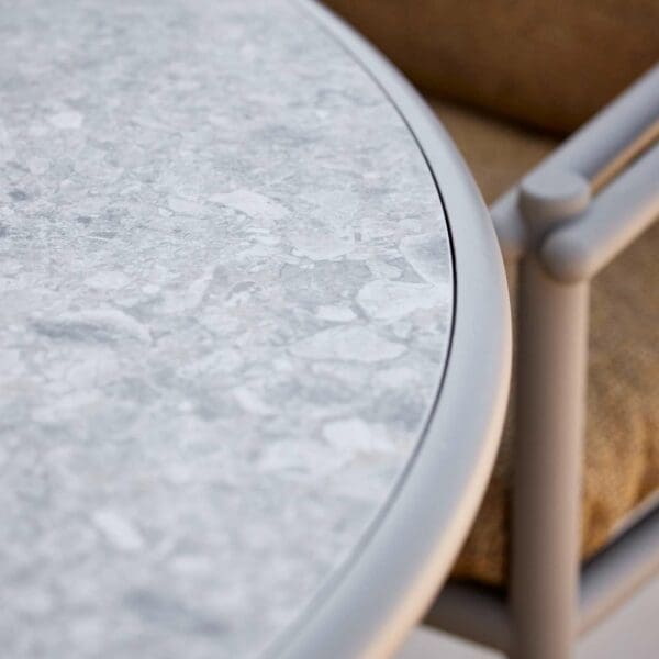 Image of detail of Glaze table's multi-coloured ceramic table top with aluminium bull nose edge by Cane-line