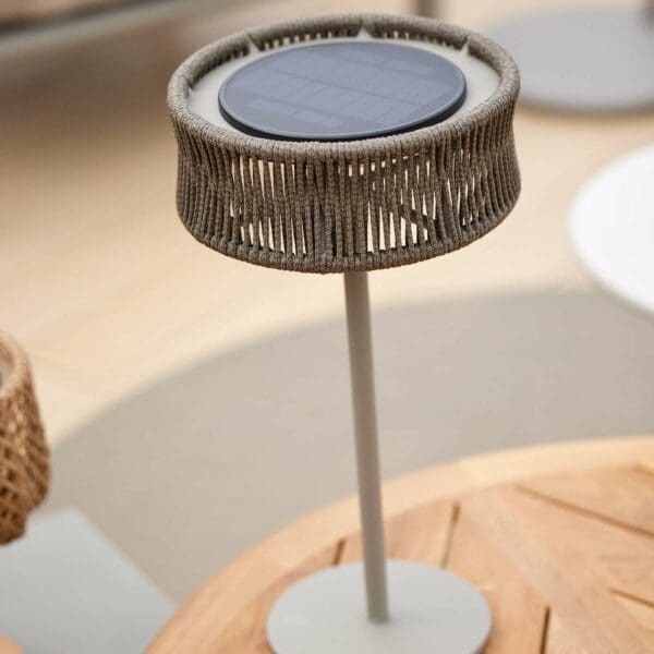 Image of Cane-line Illusion contemporary solar light on top of Cane-line round teak table