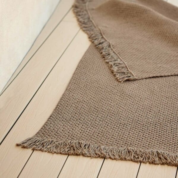 Image of detail of Cane-line Knit rectangular outdoor rug in Dark Sand polypropylene