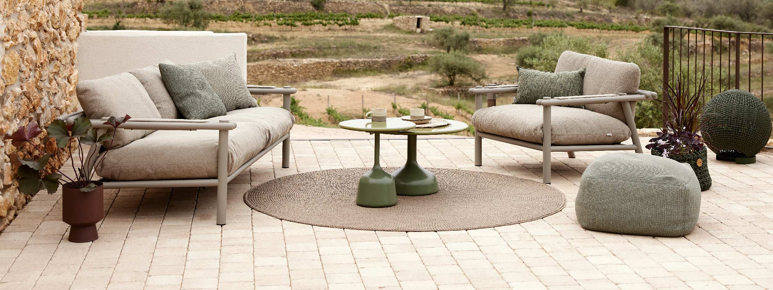 Image of Stick outdoor lounge furniture, with Knit outdoor rug and Glaze low tables in the centre