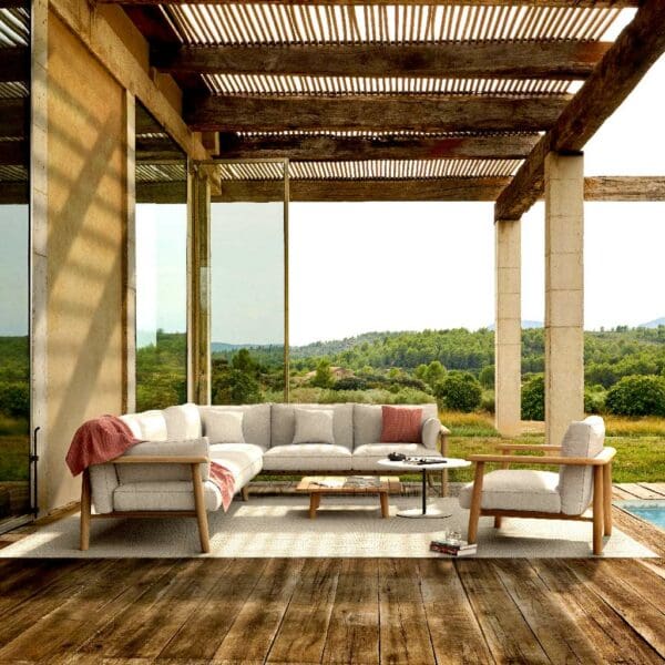 Image of Mambo Lounge teak corner sofa on decked terrace beneath linear timber pergola