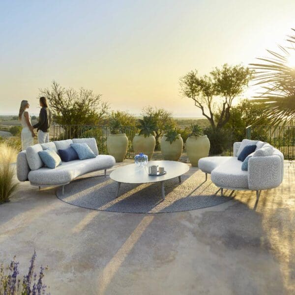 Image of pair of Organix upholstered garden sofas and Styletto elliptical coffee table on terrace in early evening sunshine