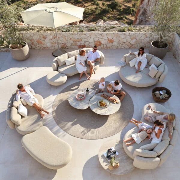Image of birds eye view of 4 Organix modern garden sofas arranged in a circle around a circular carpet and low tables in the centre