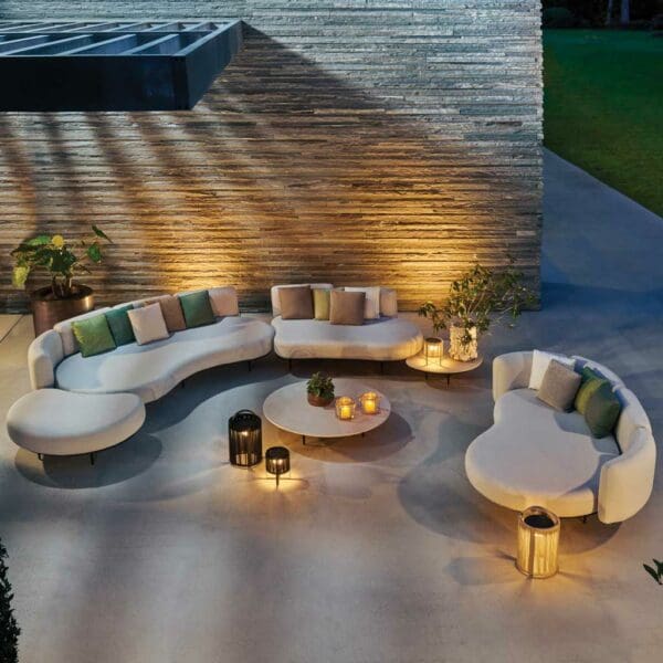 Nighttime image of illuminated terrace with pair of Organix minimalist garden sofas by Royal Botania