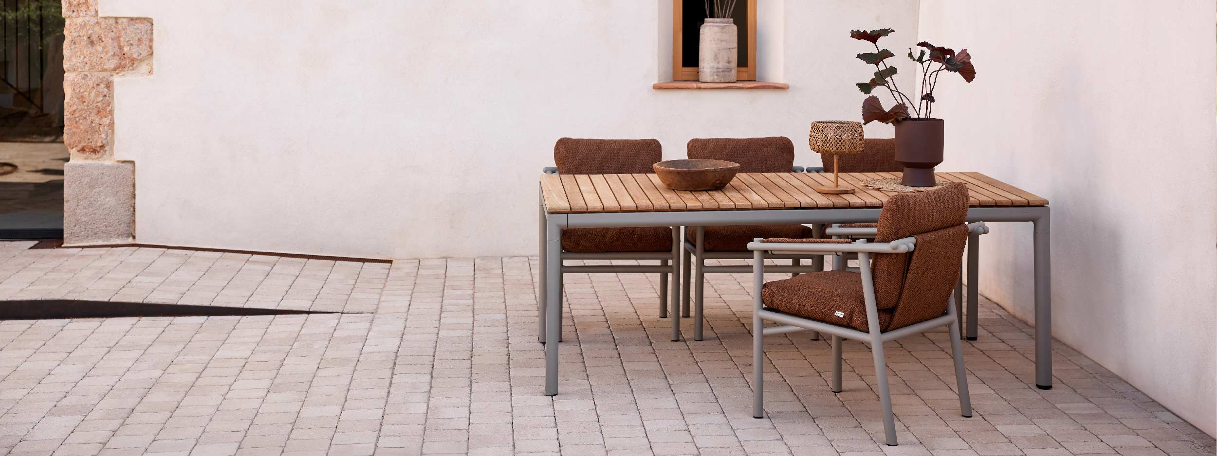 Image of Sticks taupe garden chairs with Umber-Brown cushions around Core taupe garden dining table with teak top