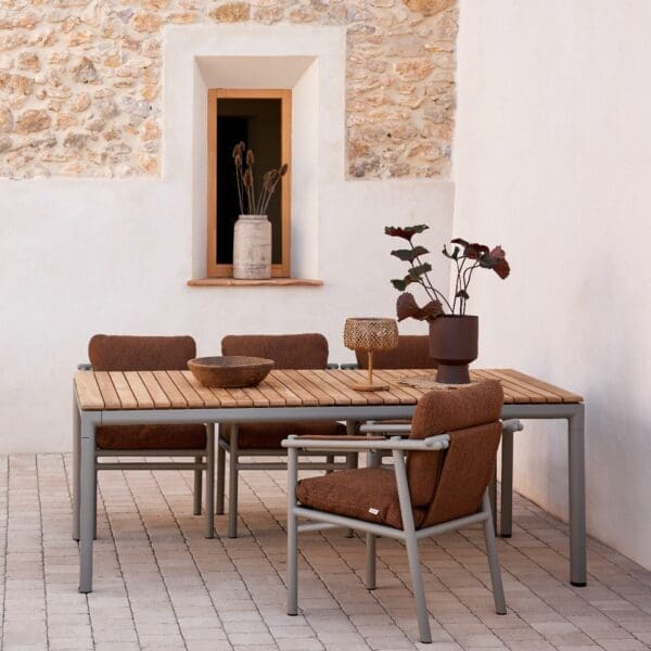 Image of Cane-line Sticks taupe garden dining chairs with Umber Brown cushions, shown around Core rectangular table