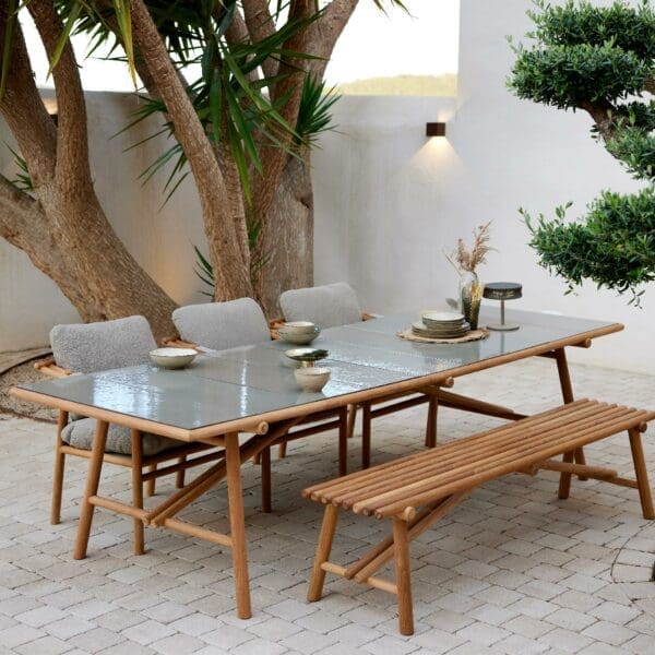 Image of Cane-line Sticks teak table and chairs with teak bench seat in the foreground