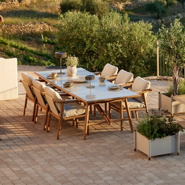 Image of Cane-line Sticks teak dining set with grey cushions and sand coloured glazed lava stone table top