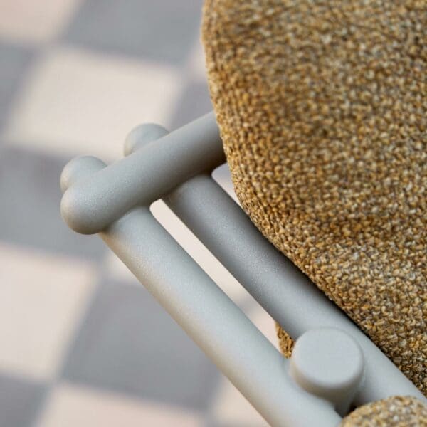 Image of detail of Cane-line Sticks taupe garden chair with Turmeric color cushion