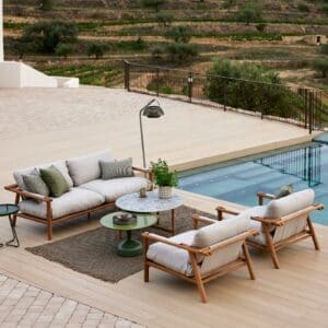 Image of aerial view of Cane-line Sticks luxury teak lounge furniture on a terrace next to a swimming pool