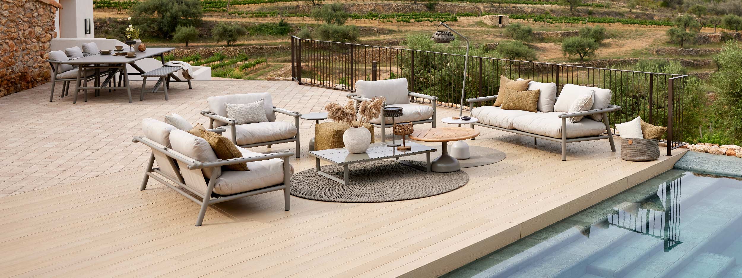 Image of Cane-line Sticks aluminium garden sofas and lounge chairs, with Sticks modern dining furniture in the background