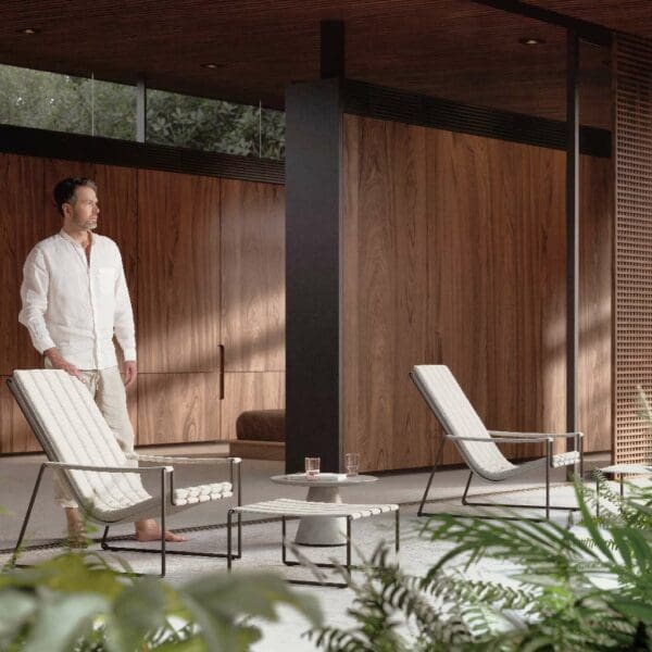 Image of chap stood behind a pair of Royal Botania Strappy lounge chairs and Conix modern concrete side table