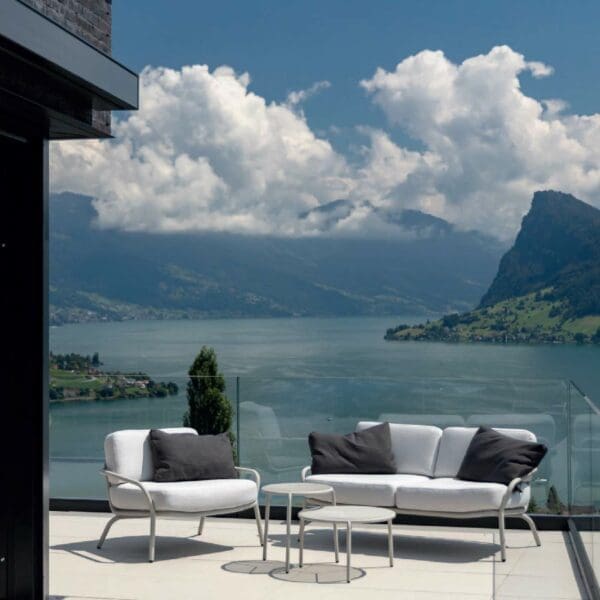 Image of Starling white lounge furniture on sunny terrace with lake and mountains in the background