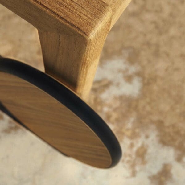 Image of detail of Zenhit sun lounger's solid teak wheel with black rubber tyre