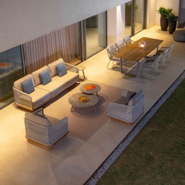 Image of birdseye view of nighttime terrace with Acri garden sofa and lounge chairs by Jati & Kebon