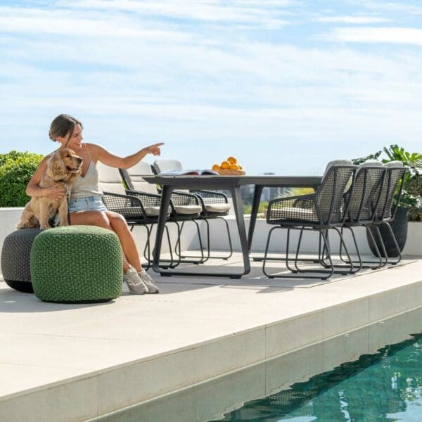 Image of ELKO ceramic dining table and Alden contemporary garden chairs on sunny poolside