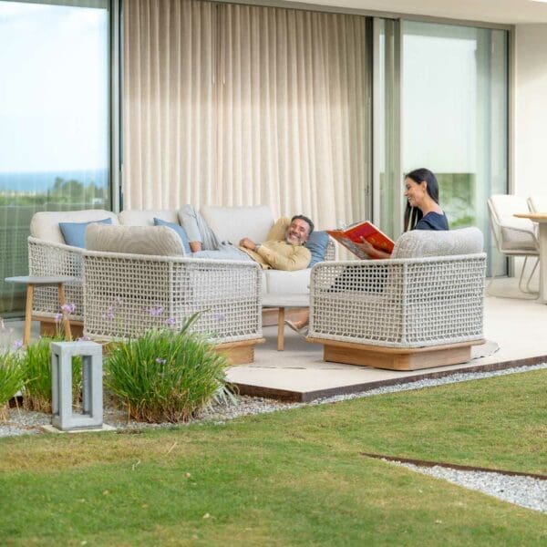 Image of man and woman relaxing on Acri contemporary garden sofa and lounge chair on swish terrace