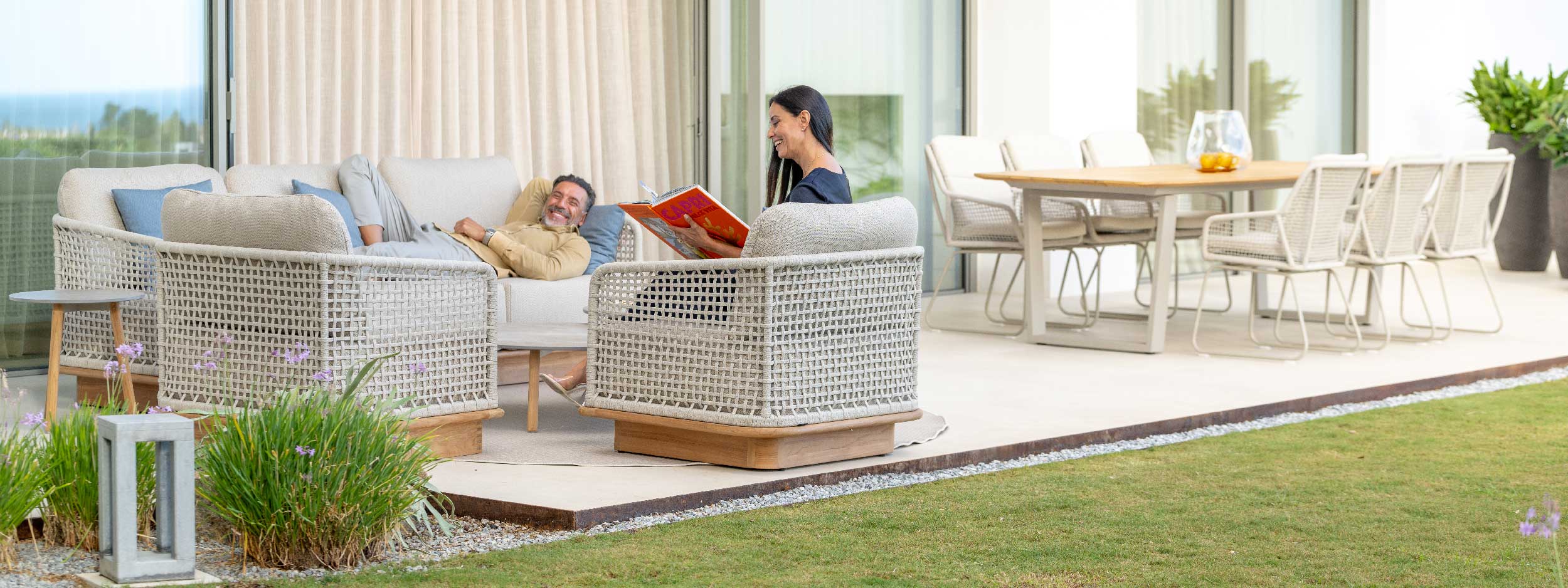 Image of couple lounging and enjoying each other's company on Acri contemporary outdoor lounge furniture, on swish terrace