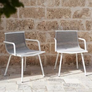 Image of pair of RODA Laze garden armchairs with white tubular frame and stone-coloured acrylic cord in sun and shade of courtyard