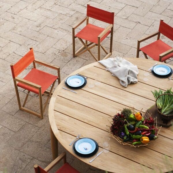 Image of Orson folding garden dining chairs around Levant round teak table by RODA