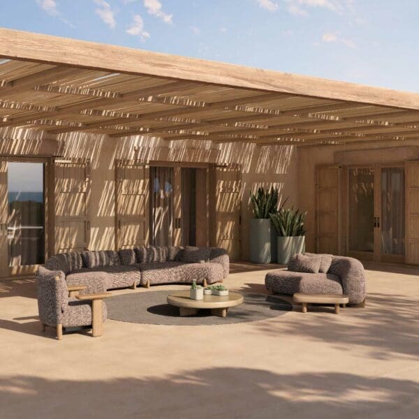 Image of Milos half circle garden sofa and lounge chairs in dappled sunshine beneath a contemporary pergola