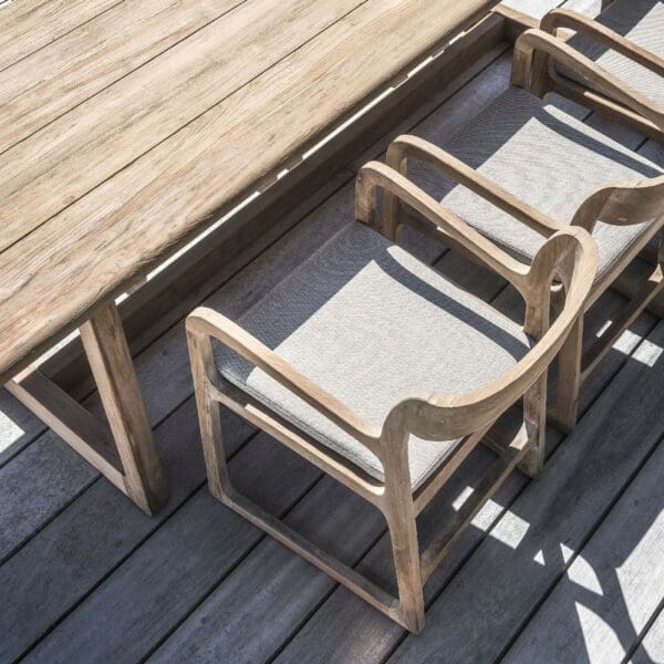 Image of Sally teak dining chairs placed around Dennis rectangular teak dining table by Gommaire