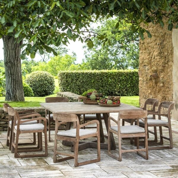 Image of 8 Sally teak armchairs placed around Dennis large square dining table by Gommaire
