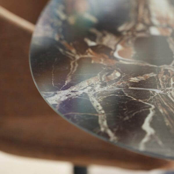 Image of detail of black, white and gold hues incaravaggio ceramic used for Central ceramic dining table by Joli