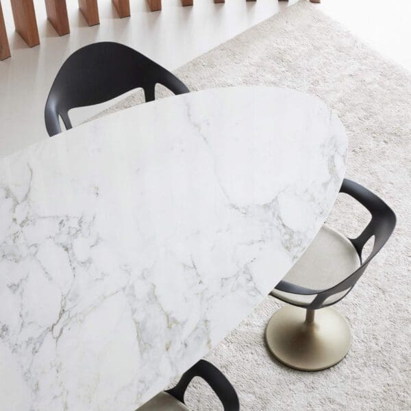 Image of aerial view of Joli Central elliptical ceramic dining table with top in calacatta finish