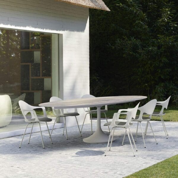 Image of Joli Central oval garden dining table with ceramic table top, surrounded by Sepia dining chairs