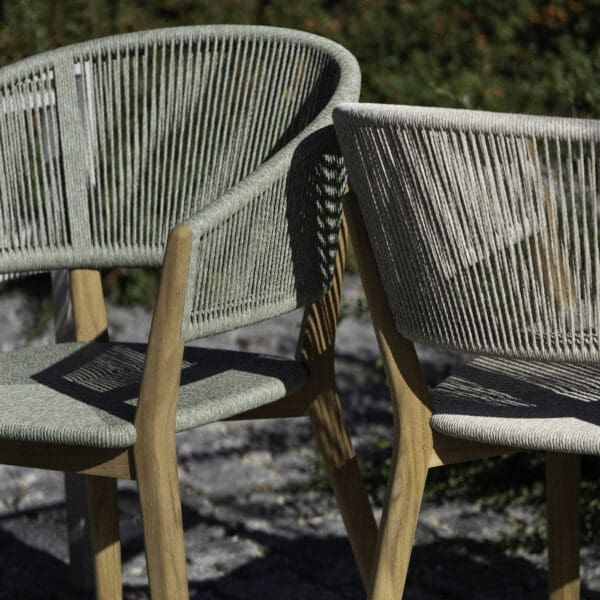 Image of pair of Cares teak garden chairs back to back with contrasting finishes of polyester rope cord