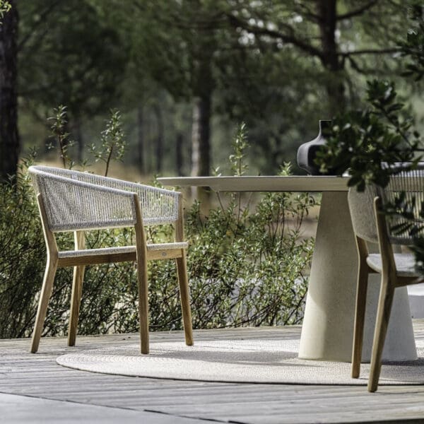 Image of pair of Cares garden chairs and Exes round cement table by Royal Botania
