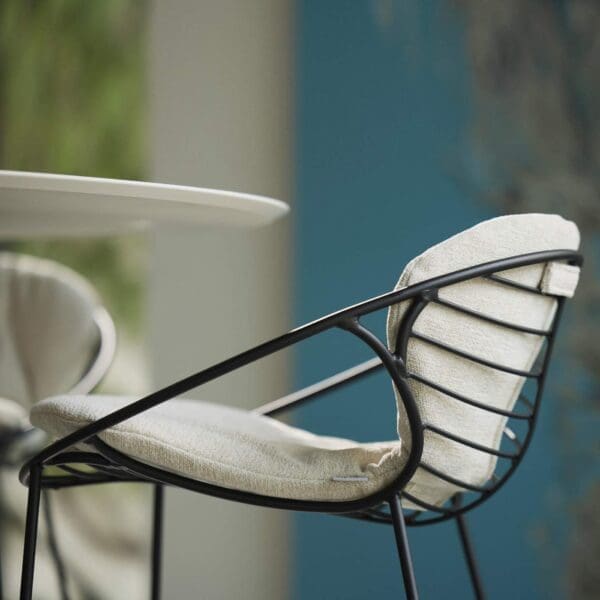 Image of detail of Wire bar stool and cushion by Joli, which is suitable for both interior and exterior use